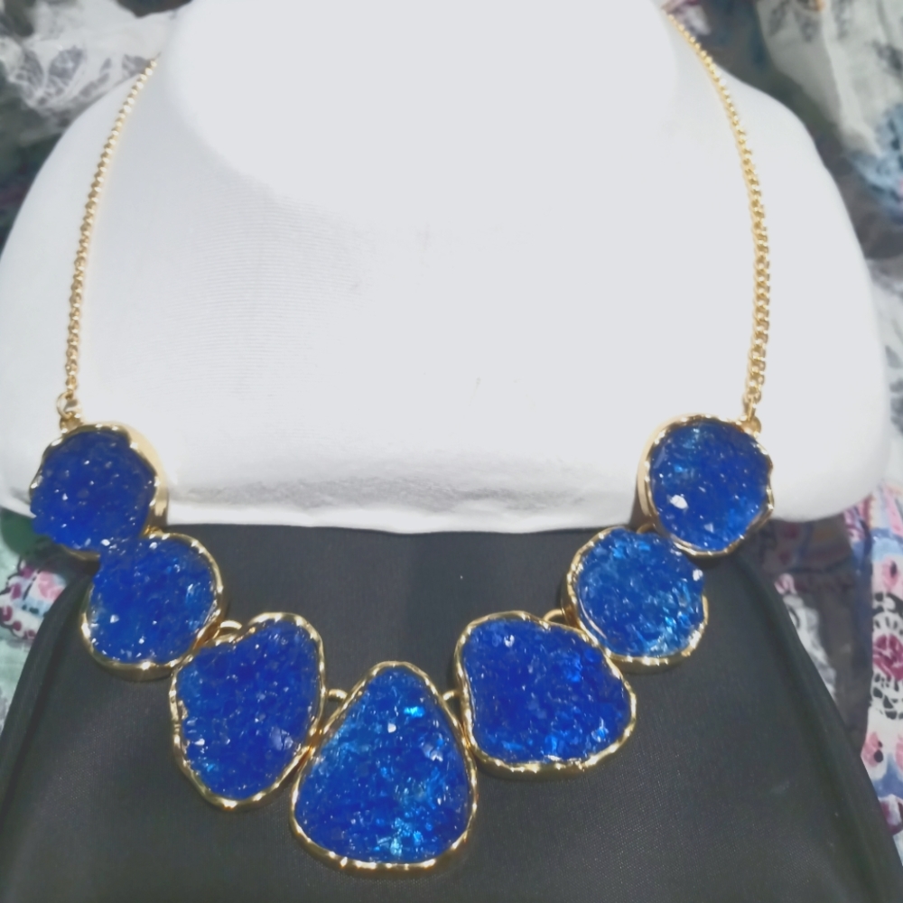 Deep regal blue accentuated on a gold chain necklace